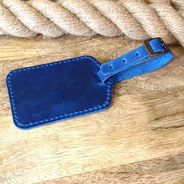 Personalized handmade luggage tag in blue leather with engraving of name, initials, monogram, logo, phone number