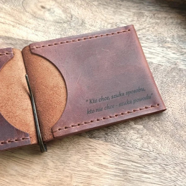 Handmade leather wallet with money clip and skull design, with personalized engraving of an image and text.