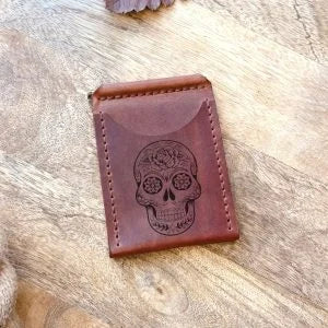 Handmade leather wallet with money clip and skull design, with personalized engraving of an image and text.