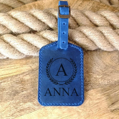Personalized handmade luggage tag in blue leather with engraving of name, initials, monogram, logo, phone number