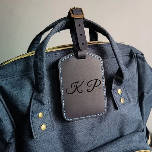 Personalized baggage tag handmade from full grain dark blue leather with engraving monogram, logo, name, initials, text and pictures etc