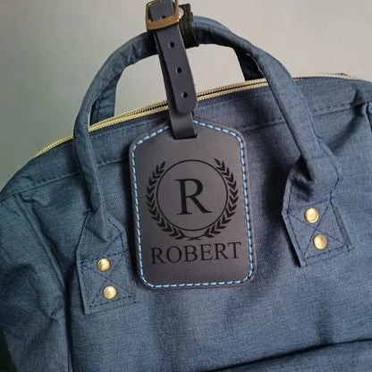 Personalized baggage tag handmade from full grain dark blue leather with engraving monogram, logo, name, initials, text and pictures etc